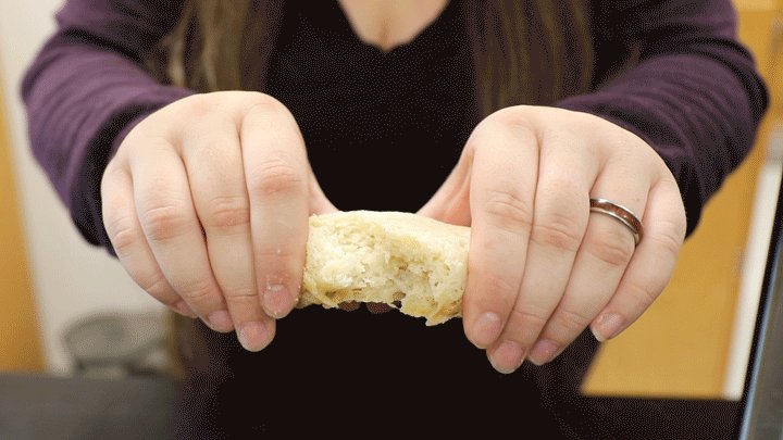 Hersh pulls apart a loaf of freshly baked space bread.