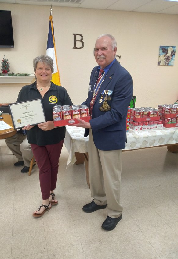 SAR President Jim Pippin presented the December meeting guest speaker Debra Austin with a certificate of appreciation, as well as 100 cans of donated soup.
