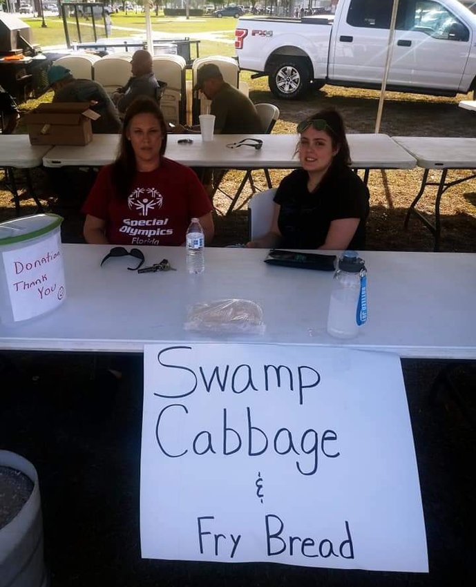 One of the ways they raised money for the wheelchair was by selling swamp cabbage and fry bread. Pictured are Robin (left) and Ashley Marker.