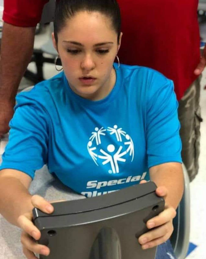 Ashley Marker helps with score keeping during Special Olympics Bowling tournament.