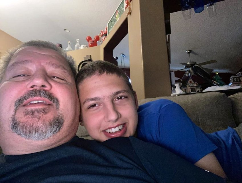 In this photo provided by Daniel Miller, single father Miller, 57, left, poses for a selfie with his son Nathan, 17, who is autistic, Friday, Feb. 11, 2022, in their home in Lake Worth, Fla. Miller, an electrical contractor, was forced to take time off from work to care for his son after the family's care provider cut off their services due to months of missing Medicaid payments. Florida failed for nearly three months to pay tens of thousands of health-care claims for the state's sickest and neediest children due to software glitches blamed on the corporate merger of its two largest payment vendors, officials and executives said. (Daniel Miller via AP)