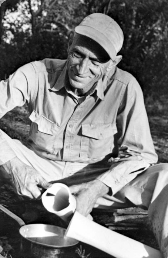 In this photo circa 1950 Everglades guide George L. Espenlaub prepares swamp cabbage.