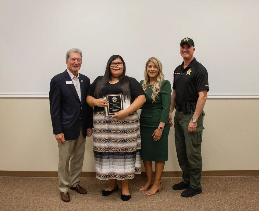 Immokalee Foundation Board Chair Jerry Belle, Academy graduate Mariceliah Cruz, Immokalee Foundation President and CEO Noemi Y. Perez, and Captain Chris Gonzales from the Collier County Sheriff's Office.