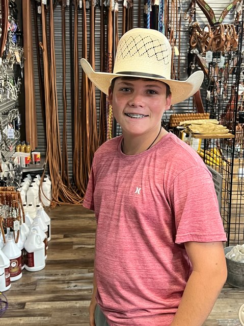 OKEECHOBEE -- Michael Sheffield, 14, is happy with his custom-shaped straw hat. The 14-year-old Freshman at Okeechobee High School is on the OHS Rodeo Team. [Photo by Katrina Elsken/Lake Okeechobee News]