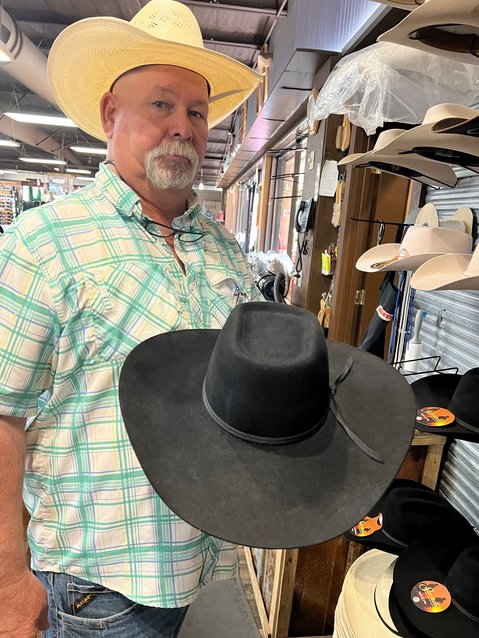 OKEECHOBEE -- Jay Crews shows off a felt hat with a box top, sometimes called a square top or Canadian. [Photo by Katrina Elsken/Lake Okeechobee News]