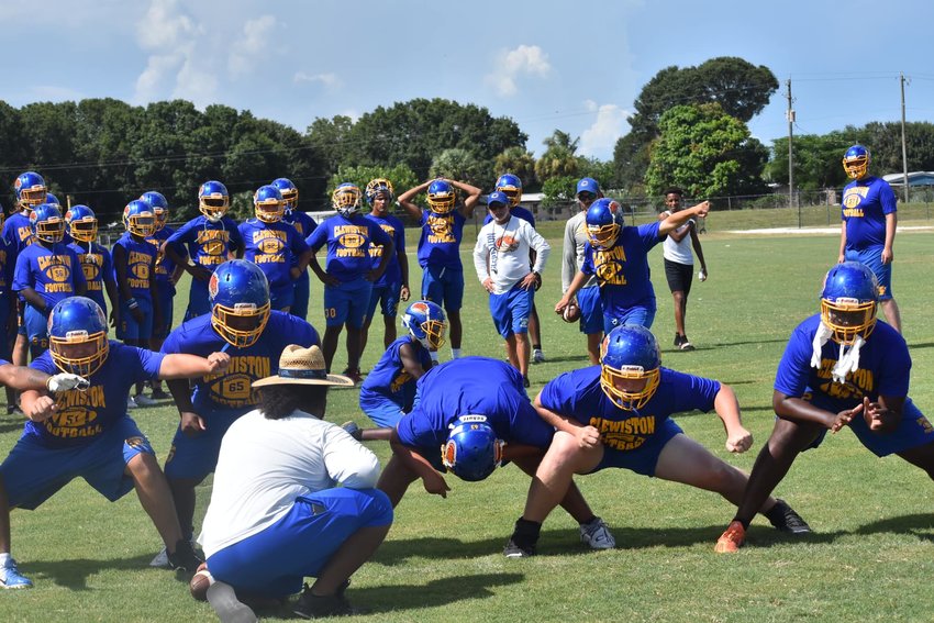 Clewiston coach Pete Walkers watches his players practice a field goal attempt.