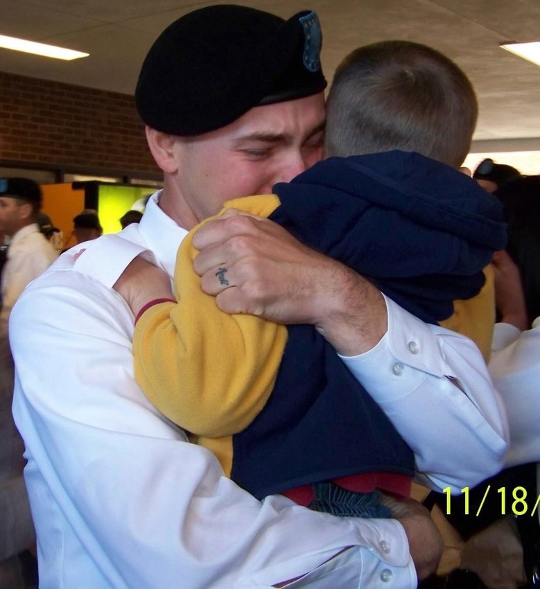 Josh Pancake hugs his son Aaron at his OSUT graduation ceremony.