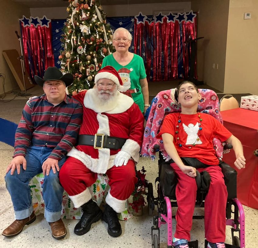 The Berry family enjoys a visit with Santa during the Christmas party.
