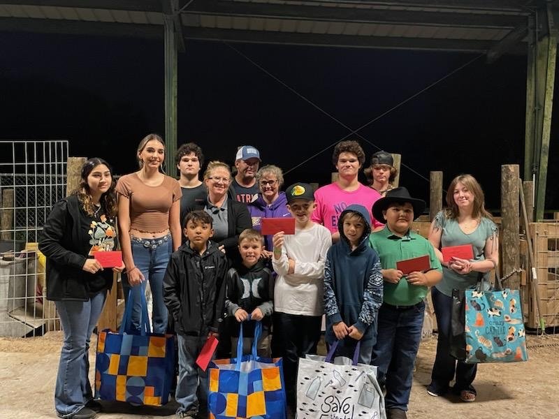 The Okeechobee Outsiders 4-H club donated gifts to veterans for the holidays. Pictured left to right are (back row) Thomas Crum, Gregg Maynard, William Crum and Matthew Hutson. (Second row) Jo'Navi Sewell, Gracie Hutson, Jessica Sewell, Betty Jo Campbell and Calleigh Teague. (Front row) Kaleb Rucker, Kamdyn Teague, Ricky Brown, Jacob Weeks and Grayson Elad.