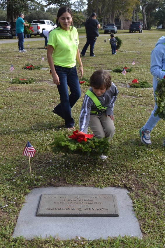 Enedina Bautista, teacher from Eastside Elementary School, and one of her students participate in Wreaths Across America. [Courtesy photo]