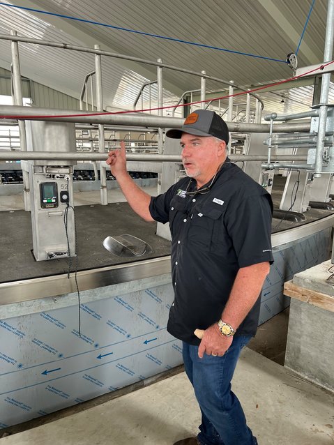 OKEECHOBEE -- Sutton Rucks shows off the rotary milking parlor currently under construction at Milkin R Dairy.