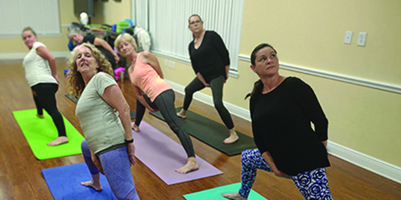 Once the spine is aligned, begin to initiate the “Full Body Extension.” The Yoga practioners at Shield Wellness Center, Sebring, demonstrate this posture: Joyce Shafer, Tamra Shafer, Maureen Farley. Tessa Hickey, Susan Kindig, Machele Albritton. [Photo courtesy Nancy Dale]