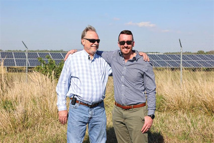 John Renfranz (right) and father Donald Renfranz (left) standing in from of the fence of FPL’s Lakeside Solar site. [Photo courtesy FPL]