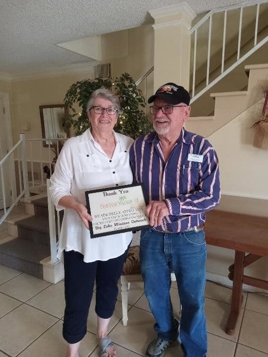 Big Lake Mission's Bruce Swinford accepts a certificate from Heritage Village.