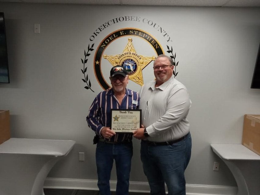 Sheriff Noel Stephen (right) presents a certificate of appreciation to Bruce Swinford of Big Lake Mission.