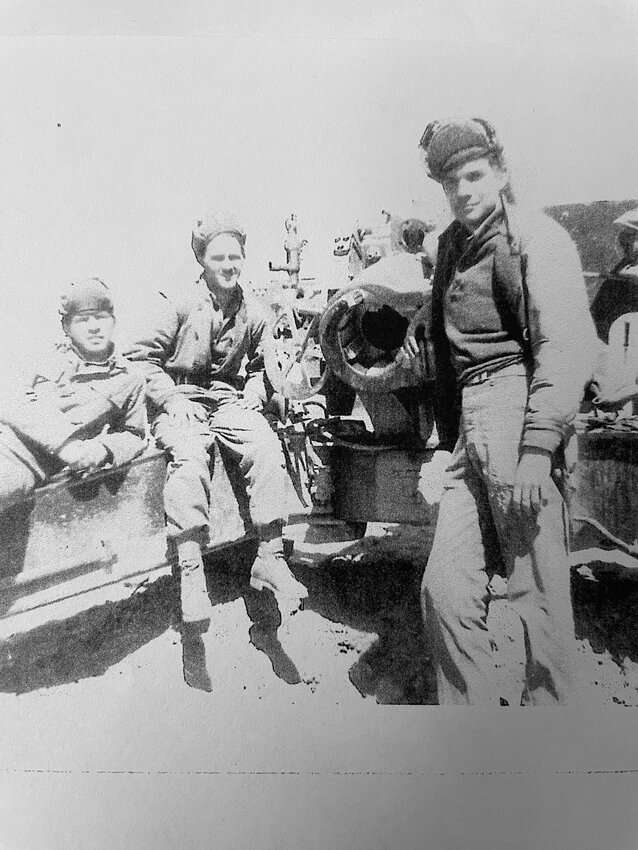 Frank Cunningham, front right, is working the breech. He said the picture was not posed. They were waiting on a fire mission.