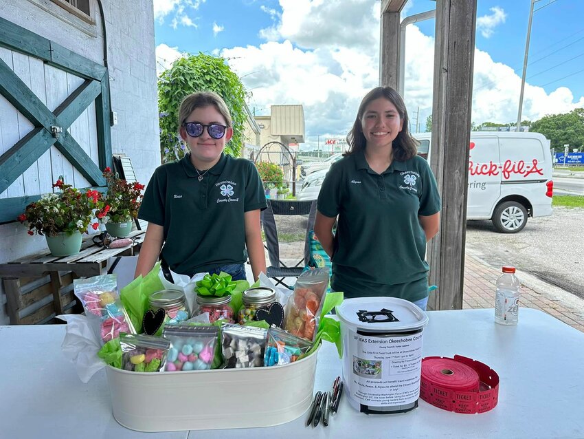 An Okeechobee 4-H group arranged to bring the Chick-fil-A truck to town as a fundraiser to help with a trip to Washington. The event took place on June 1 at Okeechobee Feed. Pictured are Reese Cohen (left) and Alyssa Cortez.