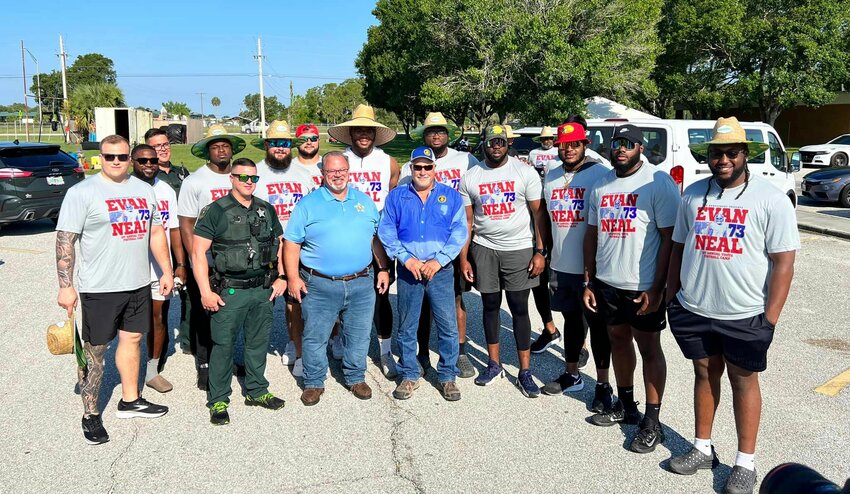 This picture makes you realize how small of a person the average man is, as standing with Evan and 9 of his fellow NFL teammates from the NY Giants are some of our deputies, one of which, Deputy Eng (back row left), is 6’4”.