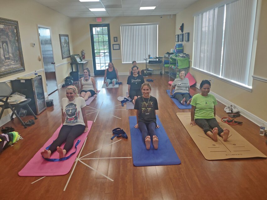 odays’ Yoga practice is demonstrated by the Shield Wellness Yoga class in Sebring, initiating a posture that aligns the spine, awakens core abdominal muscles, lengthens, and strengthens the hamstrings. This sitting posture is an extension of the standing pose “Tadassana” or “Mountain Pose.”