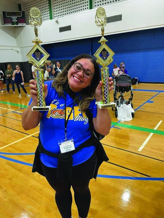 CHS cheerleading coach Grace Scarlett with the team’s first and second place trophies. [Photo courtesy of CHS Cheerleading]