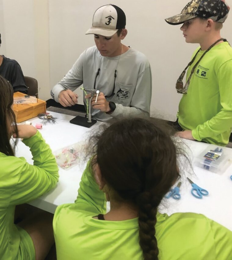 Campers chose their jig body, skirt, and feather colors while a 4-H youth volunteered to make the jigs for each participant as they watched the process.