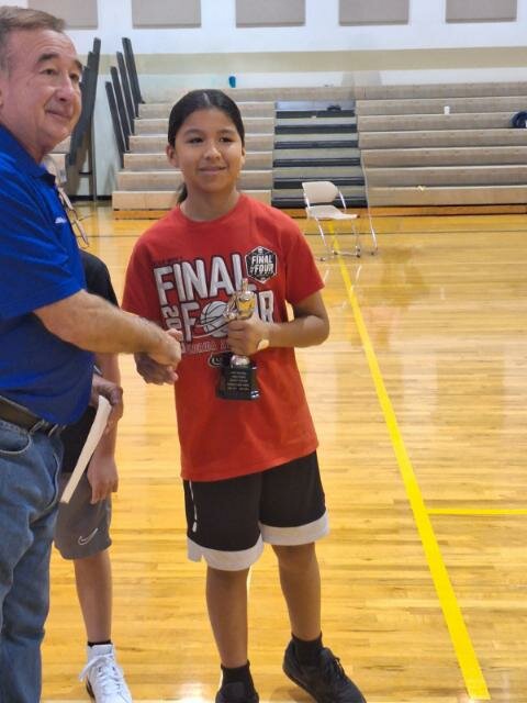 Luis Oms, Past District Deputy and District Hoop Shoot Director, in presented Rainer Robbins his award.