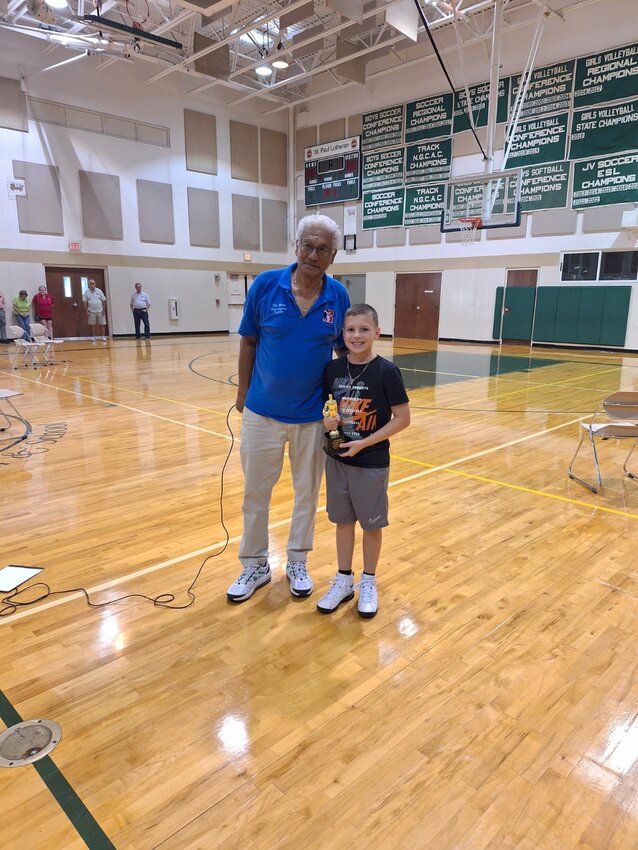 Elks South Region Hoop Shoot  Director Tito Young presented Carter Combass' trophy.