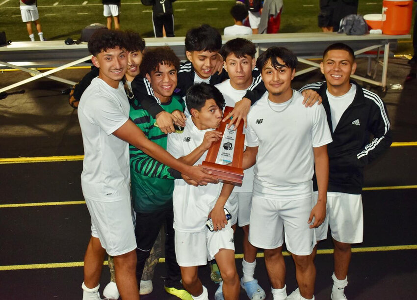 Brahman players celebrate with their trophy. [Photo courtesy OHS Boys Soccer]