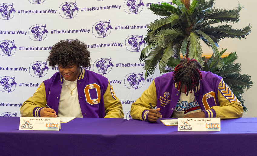 Santana Alvarez and Ni'marion Bryant sign their letters of intent. [Photo by Richard Marion]