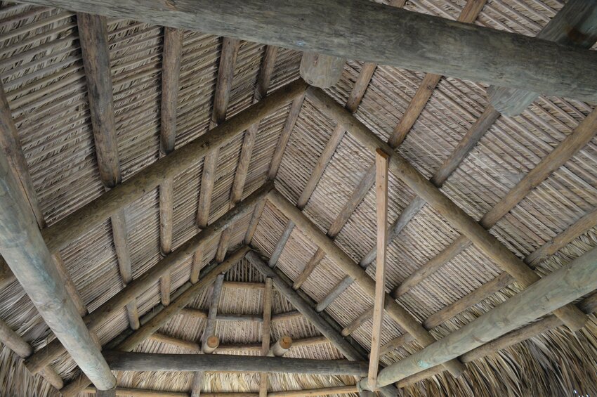 In the traditional village chickees are covered with woven palm fronds. [Photo by Katrina Elsken/Lake Okeechobee News]