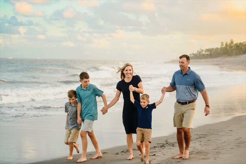 Stevany and Blake Cole, and their three energetic boys eagerly anticipated the adventures awaiting them on the shores of Juno Beach. [Photo by Amber Pellicon]
