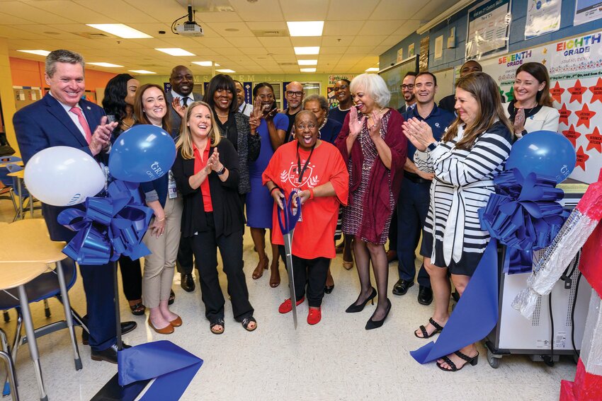Florida Power & Light Company, Palm Beach County School District and the Education Foundation of Palm Beach County employees cheer as Lake Shore Middle school STEM teacher, Phyllis Handford reveals her new classroom makeover on Thursday, Feb. 15.  [Photo by Doug Murray/FPL]