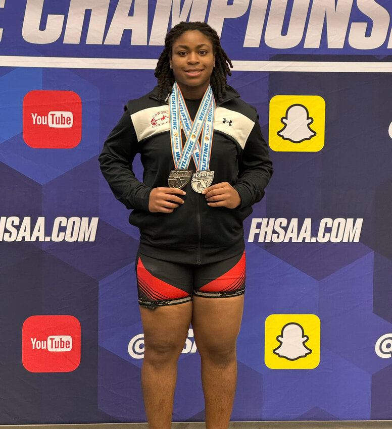 Imani Greaves with her second and fifth place medals at the FHSAA state weightlifting competition. [Photo courtesy Clewiston High School]