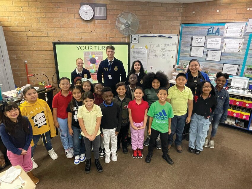 CLEWISTON -- On Feb. 21, Clewiston High School FFA members visited Eastside Elementary School to teach second grade students about how plants grow. They also helped the kids make flower Oreo treats. [Photo courtesy Eastside Elementary School]