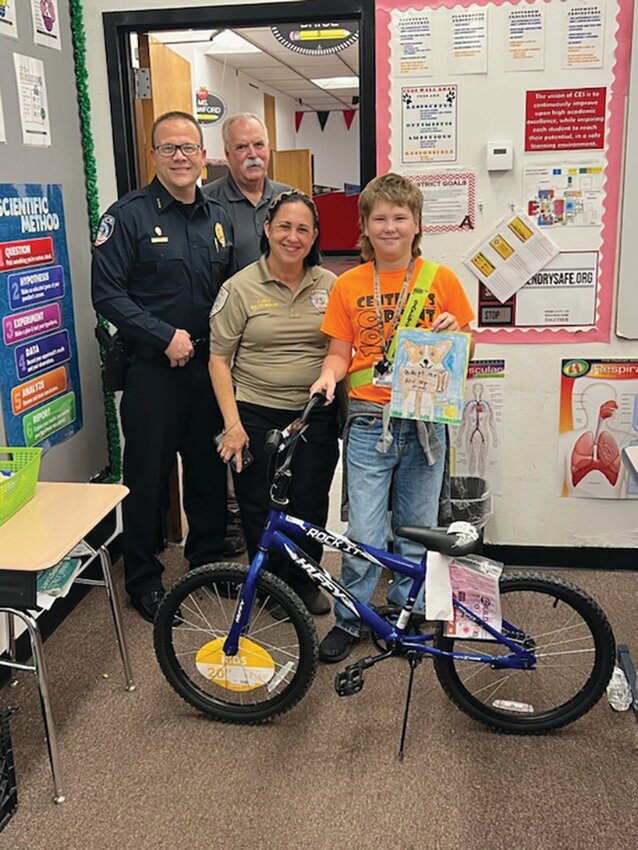 CLEWISTON --  The Central Elementary School winner to the Clewiston Animal Services art contest, Ty Davis, won a new bike for his efforts on bringing awareness to the shelter and the need to spay and neuter. Chief Lewis, Commander Brophy, and Shelter Manager Cruz presented the bike to him in front of his whole class. His artwork will be framed and permanently displayed at the shelter! [Photo courtesy Central Elementary School]