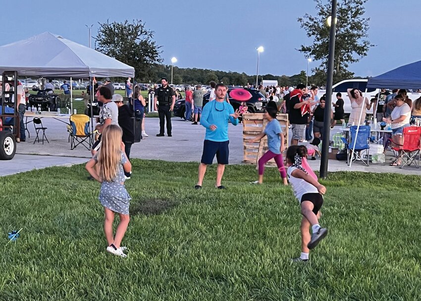 OKEECHOBEE -- While waiting for the fireworks, sojme people threw Frisbees and balls. Some played cornhole. [Photo by Katrina Elsken/Lake Okeechobee News]