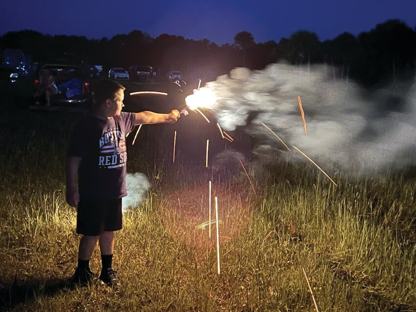 OKEECHOBEE -- Cole Curtis had fun with a sparkler while waiting for the community fireworks show to start on July 6 at the Okeechobee Agri-Civic Center. [Photo by Katrina Elsken/Lake Okeechobee News]