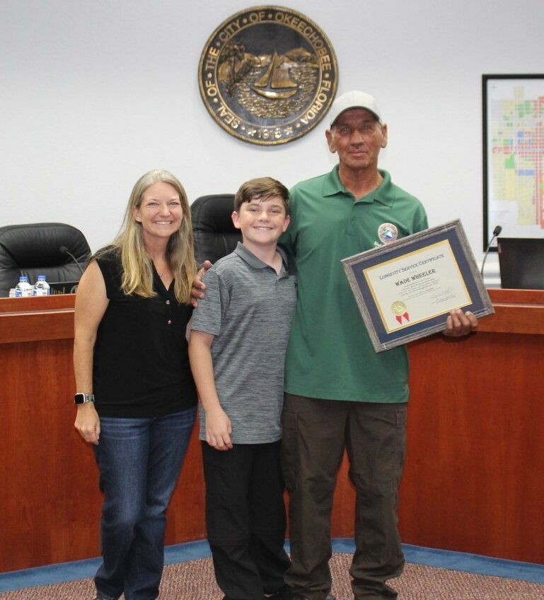 OKEECHOBEE — Okeechobee City public works employee Wade Wheeler was recognized during the July 16 city council meeting for five years of service to the city.

Wheeler thanked his wife Corey for supporting him through his career change. "What started out as quite a learning process for me 5 years ago starting all over in a new work place , I’m happy with where I’ve been able to go thus far and the feeling of having an impact on the city and department in a positive way . Thanks to our department and city management for allowing me to contribute in my way and giving me the opportunity to prove myself as a skilled operator. Looking forward to many more years of watching Willie Hall Jr. accumulate gray hair while dealing with my particular quirks . Thanks to Marvin Roberts for allowing me to jump in and give my input as we tackle the multitude of challenges we face daily."

Pictured with Wheeler are his wife Corey and son Cade.