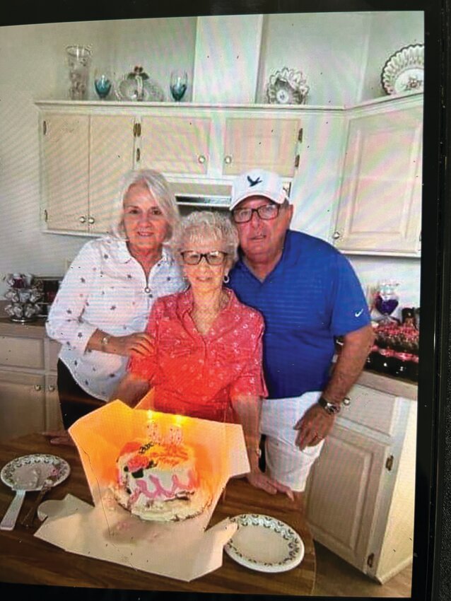 Mary West (center) celebrates her 100th birthday this month. This picture was taken a few years ago. She is with her nephew John, and his wife Susan..[Photo courtesy Mary West]