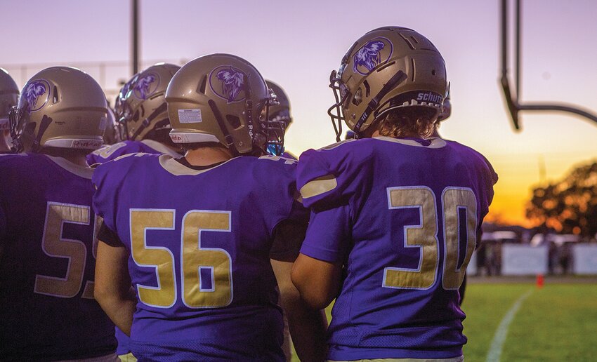 The Brahmans huddle before taking the field. [Photo by Richard Marion/Lake Okeechobee News]