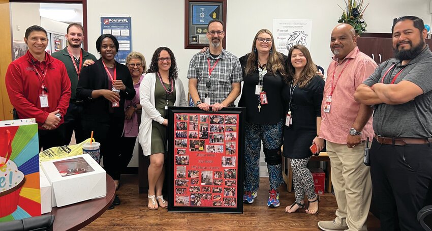 LMS principal John Klinger recieves a gift from LMS staff for his birthday. [Photo courtesy LMS]