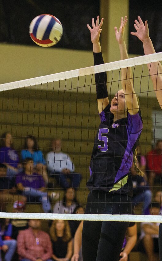 Aubrey Clay goes up for a block against Lake Placid. [Photo by Richard Marion/Lake Okeechobee News]