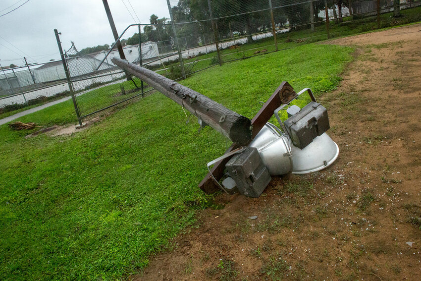 A light pole was blown onto the backstop at the baseball field near Kiwanis Park during Hurricane Ian. [Photo by Richard Marion]