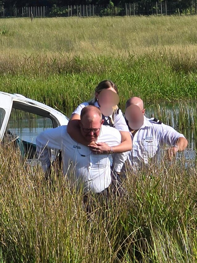 Okeechobee County Fire Rescue Chief Earl Wooten carries a passenger on his back. [Photo courtesy OCFR]