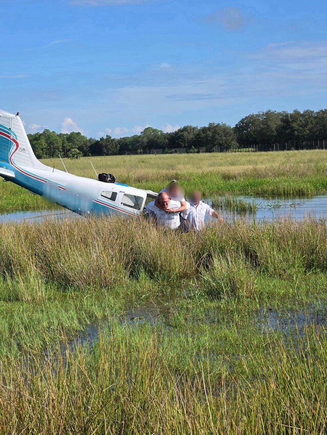 Okeechobee County Fire Rescue Chief Earl Wooten carries a passenger on his back. [Photo courtesy OCFR]