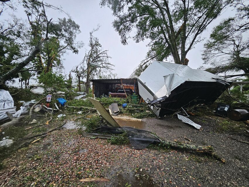 OKEECHOBEE -- The tornado that went through Dixie Ranch Estates uprooted trees, flipped vehicles and trailers and damaged homes. [Photo by Katrina Williams]