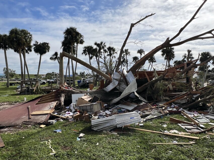 LAKEPORT -- A Lakeport resident was in her home on Oct. 9, when a tornado lifted it and smashed it into a tree. She was rescued and transported to a hospital. In the background at left is the home's front porch. In the distance is the Herbert Hoover Dike. [Photo by Katrina Elsken/Lake Okeechobee News]