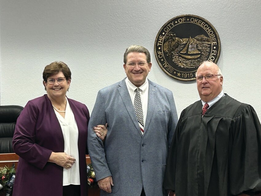 Tuesday morning, Dec. 31. Clark served as vice mayor during her last term and said her goal is to serve her city as well as her father served the city of Belle Glade during his life time. Her husband Jim Clark is pictured with her and Judge Wallace..[Photo by Cathy Womble/Lake Okeechobee News]