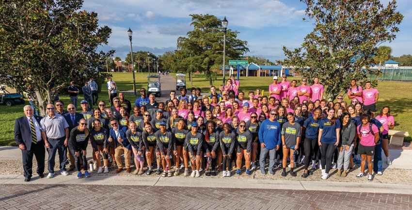 National Champion Women's Swimming & Diving and softball teams gather with their coaches and college leadership to commemorate National Champions Way.