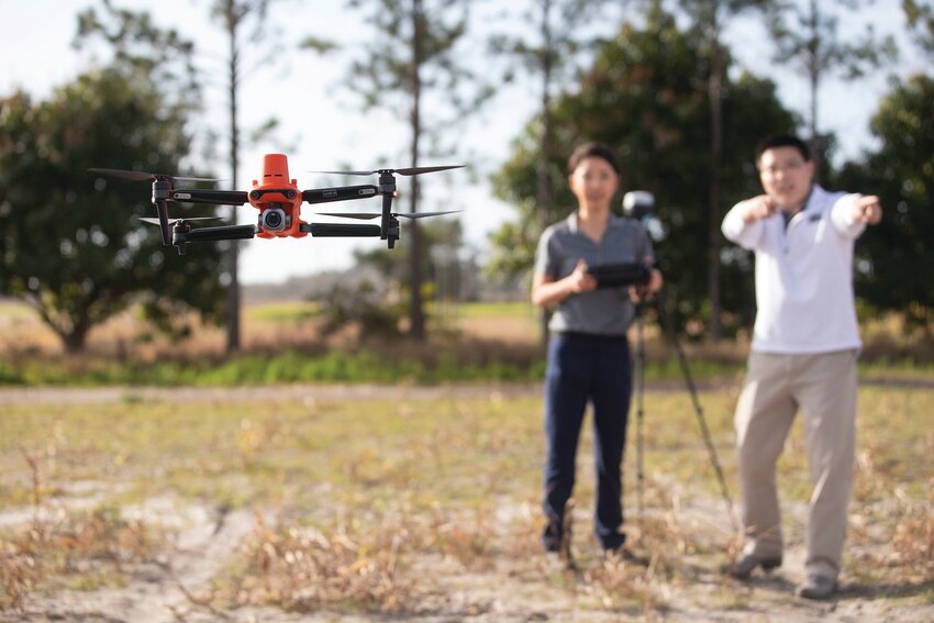 UF/IFAS researchers fly a drone to survey crops at the Gulf Coast Research and Education Center in Wimauma.